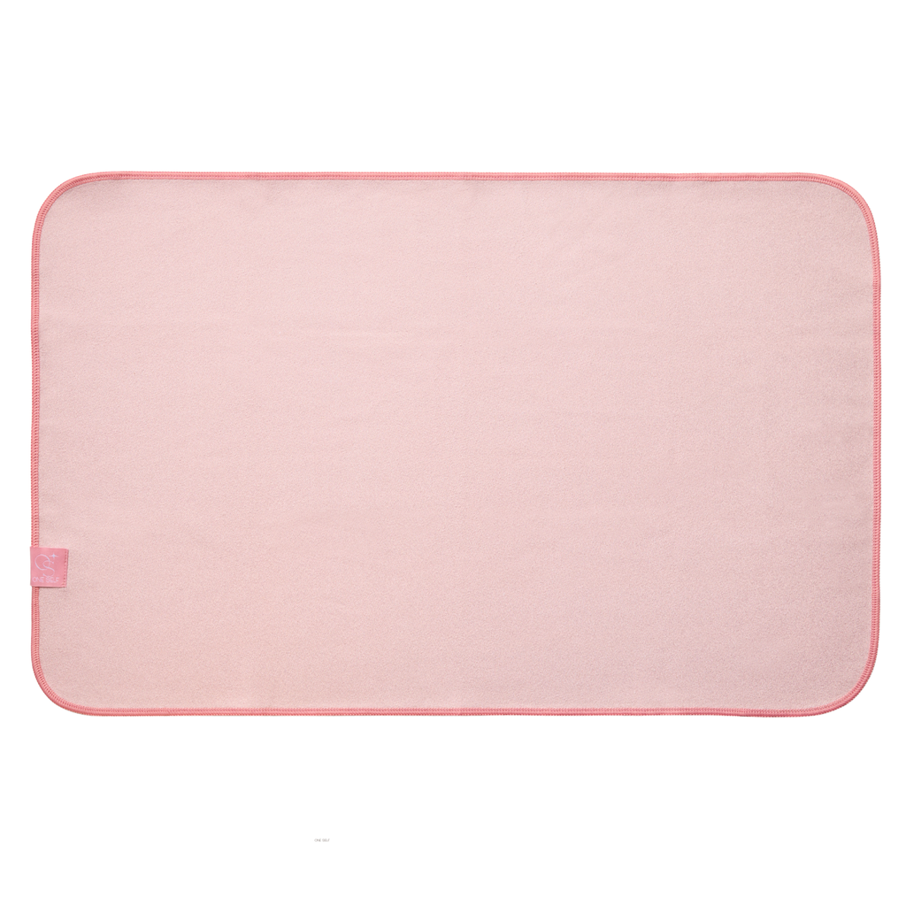 Pink hand towel mat with a small pink tag on a white background