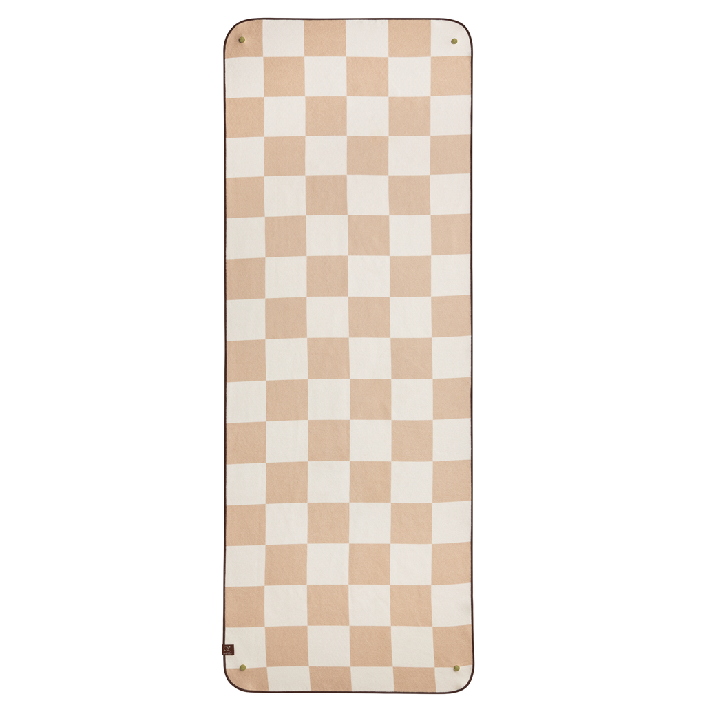 Checkered yoga mat towel with beige and white squares on a white background