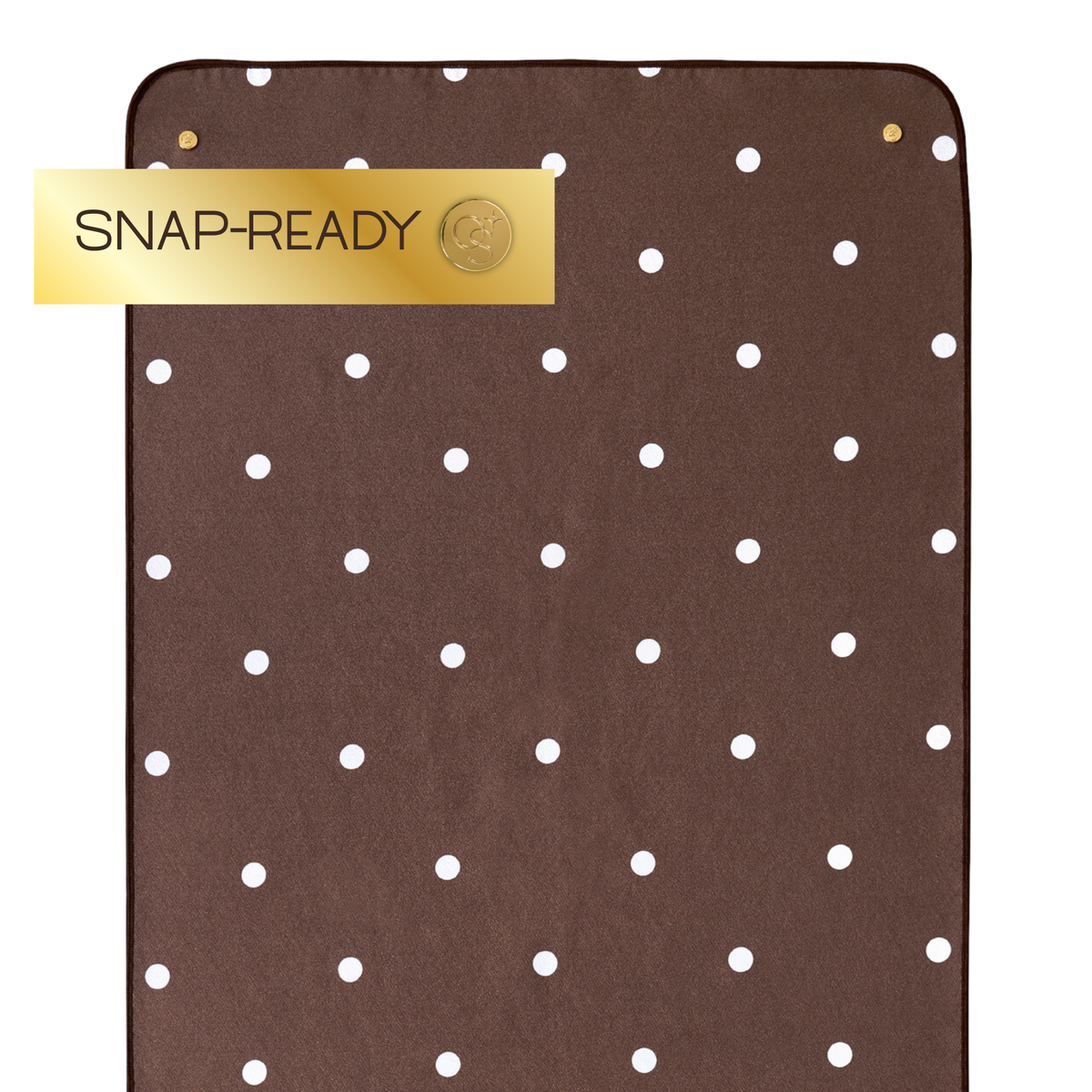 brown yoga mat towel with polka dots and label that says "snap-ready" 